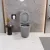   HD Dream Matt Grey perem nélküli mély öblítésű íves monoblokkos WC alsó kifolyású slim "P" tetővel és matt fekete nyomógombbal + tartály